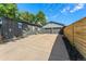 Backyard featuring a detached garage with a concrete driveway and privacy fencing at 5601 E Colorado Ave, Denver, CO 80224