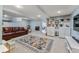 Finished basement with a comfortable leather couch, colorful rug, and white built-ins at 5601 E Colorado Ave, Denver, CO 80224