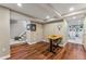 Finished basement with hardwood floors, office space, and carpeted stairs at 5601 E Colorado Ave, Denver, CO 80224