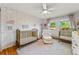 Bright Bedroom with two cribs, floral wallpaper, plush chair, and a ceiling fan at 5601 E Colorado Ave, Denver, CO 80224