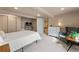 Cozy bedroom featuring neutral tones, plush carpet, desk area, and comfortable furnishings at 5601 E Colorado Ave, Denver, CO 80224
