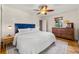 Cozy bedroom featuring a plush bed, wooden dresser, and stylish ceiling fan at 5601 E Colorado Ave, Denver, CO 80224