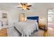 Comfortable bedroom with a blue headboard, ceiling fan, and ensuite bathroom at 5601 E Colorado Ave, Denver, CO 80224