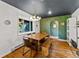 Stylish dining room with hardwood floors, colorful wallpaper, and modern lighting fixture at 5601 E Colorado Ave, Denver, CO 80224