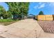 The spacious driveway leads to a two-car garage, enhanced by a modern fence at 5601 E Colorado Ave, Denver, CO 80224