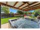 Backyard showcasing a large hot tub under a covered patio, perfect for outdoor relaxation and entertaining at 5601 E Colorado Ave, Denver, CO 80224