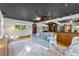 Well-lit living room featuring hardwood floors, modern lighting, and a view of the kitchen at 5601 E Colorado Ave, Denver, CO 80224