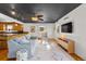Open-concept living area with wood floors, a view of the kitchen, and a modern ceiling at 5601 E Colorado Ave, Denver, CO 80224