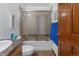 A functional bathroom features a shower-tub combo with a sliding door, and a classic vanity at 4825 S Ammons St # 113, Littleton, CO 80123