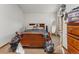 Bedroom with bed, dresser, and decor that adds character and functionality to the space at 4825 S Ammons St # 113, Littleton, CO 80123