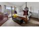 Bright bedroom with a four-poster bed, carpet, and a window providing natural light at 4825 S Ammons St # 113, Littleton, CO 80123