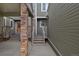 Covered entrance with brick pillars leading to the front door, creating a welcoming feel at 4825 S Ammons St # 113, Littleton, CO 80123