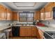 Kitchen boasting wood cabinets, granite countertops, modern appliances, and stylish finishes at 4825 S Ammons St # 113, Littleton, CO 80123