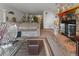 Open living area with a cozy fireplace and a seamless flow to dining and staircase at 4825 S Ammons St # 113, Littleton, CO 80123