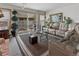 Bright living room with sliding door access to outdoor area, plush seating, and stylish decor at 4825 S Ammons St # 113, Littleton, CO 80123