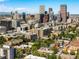 Stunning aerial view of city skyline with iconic buildings, showcasing urban living and mountain views at 1100 N Logan St # 9, Denver, CO 80203