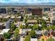 High-angle shot of neighborhood, featuring tree-lined streets and diverse housing styles at 1100 N Logan St # 9, Denver, CO 80203
