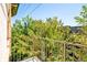 Private balcony featuring iron railing with views of lush trees in a well-maintained community at 1100 N Logan St # 9, Denver, CO 80203