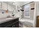 Cozy bathroom with decorative tiles, a sleek vanity, a combined tub and shower and essential fixtures at 1100 N Logan St # 9, Denver, CO 80203