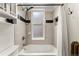 Cozy bathroom with decorative tiles, a shower/tub combination and essential fixtures that create a functional space at 1100 N Logan St # 9, Denver, CO 80203
