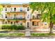 Charming apartment building featuring multiple balconies, well-maintained landscaping, and a welcoming entrance at 1100 N Logan St # 9, Denver, CO 80203