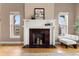 Elegant fireplace with decorative mantel, red brick surround, and a cozy seating area nearby at 1100 N Logan St # 9, Denver, CO 80203