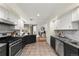 Updated kitchen with stainless steel appliances, granite countertops, and stylish black and white cabinets at 1100 N Logan St # 9, Denver, CO 80203