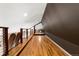 An open and airy loft space featuring hardwood floors and an industrial railing showcasing versatile potential at 1100 N Logan St # 9, Denver, CO 80203