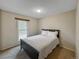 Bedroom with neutral carpet, a window, and a queen bed featuring white linens at 17148 E Evans Dr, Aurora, CO 80013
