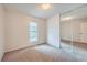 Bedroom with a window, carpet, and sliding mirrored closet doors at 17148 E Evans Dr, Aurora, CO 80013