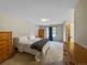 Spacious bedroom with neutral carpet, large window, and wooden furniture at 17148 E Evans Dr, Aurora, CO 80013