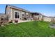 Inviting backyard with patio, outdoor dining, grill, and well-maintained lawn at 7227 Clarke Dr, Frederick, CO 80530