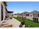 Spacious backyard featuring a patio, dining area, garden beds and trampoline at 7227 Clarke Dr, Frederick, CO 80530