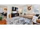 Cozy living room showcasing stylish decor, a comfortable sofa, and a large-screen television at 7227 Clarke Dr, Frederick, CO 80530