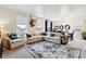 Bright living room with large sectional sofa, decorative rug, and natural light from the windows at 7227 Clarke Dr, Frederick, CO 80530