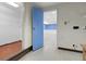 Basement with storage leading to a bright blue room, offering potential for various uses at 1091 E Pinewood Ave, Centennial, CO 80121