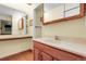 Bathroom featuring a vanity with a marble countertop and wooden cabinets and shelving space at 1091 E Pinewood Ave, Centennial, CO 80121