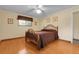 Comfortable bedroom with hardwood floors, ceiling fan, and a window providing natural light at 1091 E Pinewood Ave, Centennial, CO 80121