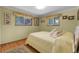 Bedroom featuring neutral walls, natural light from two windows, and hardwood floors at 1091 E Pinewood Ave, Centennial, CO 80121