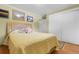 Bright bedroom with hardwood floors, closet, and sunny yellow decor for a cozy atmosphere at 1091 E Pinewood Ave, Centennial, CO 80121