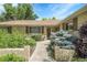 Charming home entrance with brick accents, lush landscaping, and decorative outdoor lighting at 1091 E Pinewood Ave, Centennial, CO 80121