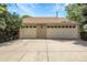 Spacious two-car garage with a brick exterior and a large concrete driveway providing ample parking space at 1091 E Pinewood Ave, Centennial, CO 80121