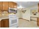 A bright kitchen featuring wood cabinets, stainless steel microwave, and an open design at 1091 E Pinewood Ave, Centennial, CO 80121