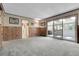 Inviting living room with carpet floors and access to sunroom through sliding glass doors at 1091 E Pinewood Ave, Centennial, CO 80121