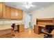 Spacious home office with custom built-in desks, wood floors, and ample storage at 1091 E Pinewood Ave, Centennial, CO 80121