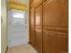A large pantry features plenty of storage cabinets and a white door with glass at 1091 E Pinewood Ave, Centennial, CO 80121