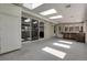 Bright sunroom featuring skylights, tile floors, and sliding glass doors at 1091 E Pinewood Ave, Centennial, CO 80121