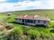 Aerial view of charming home with green grass, mountain views and separate storage building at 8602 N 39Th St, Longmont, CO 80503