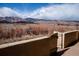 Backyard featuring mountain views beyond a stone wall and wooden gate at 8602 N 39Th St, Longmont, CO 80503