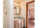 Bathroom featuring a single sink vanity, walk-in shower and wood trim at 8602 N 39Th St, Longmont, CO 80503